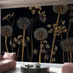 Pissenlits et herbes folles sur fond noir, aux reflets couleur laiton, dans un loft moderne.