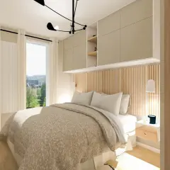 Une chambre parentale lumineuse avec un lit douillet, des rangements muraux et une vue sur un jardin fleuri.