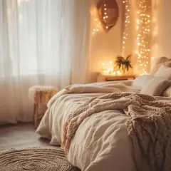 Chambre cosy avec lit douillet, coussins moelleux, plaid en maille et guirlande lumineuse.