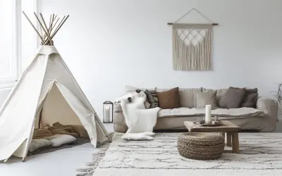 Un coin jeux enfant salon avec une tente tipi, coussins douillets et un tapis douillet.
