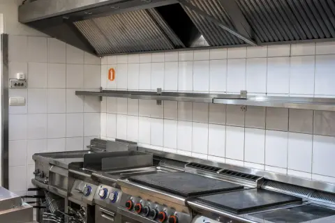 Hotte de cuisine professionnelle en inox, garantissant une grande puissance d'extraction pour un environnement de travail sain.
