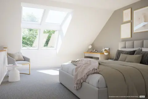 Chambre mansardée cocooning baignée de lumière naturelle grâce aux fenêtres de toit. Un lit douillet, un fauteuil invitant et un bureau complètent cet espace paisible.