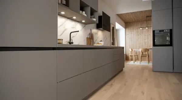 Cuisine moderne et épurée, une cuisine sans poignée aux lignes nettes. Le plan de travail en marbre contraste avec les façades grises.