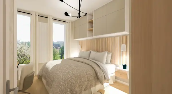 Une chambre parentale lumineuse avec un lit douillet, des rangements muraux et une vue sur un jardin fleuri.