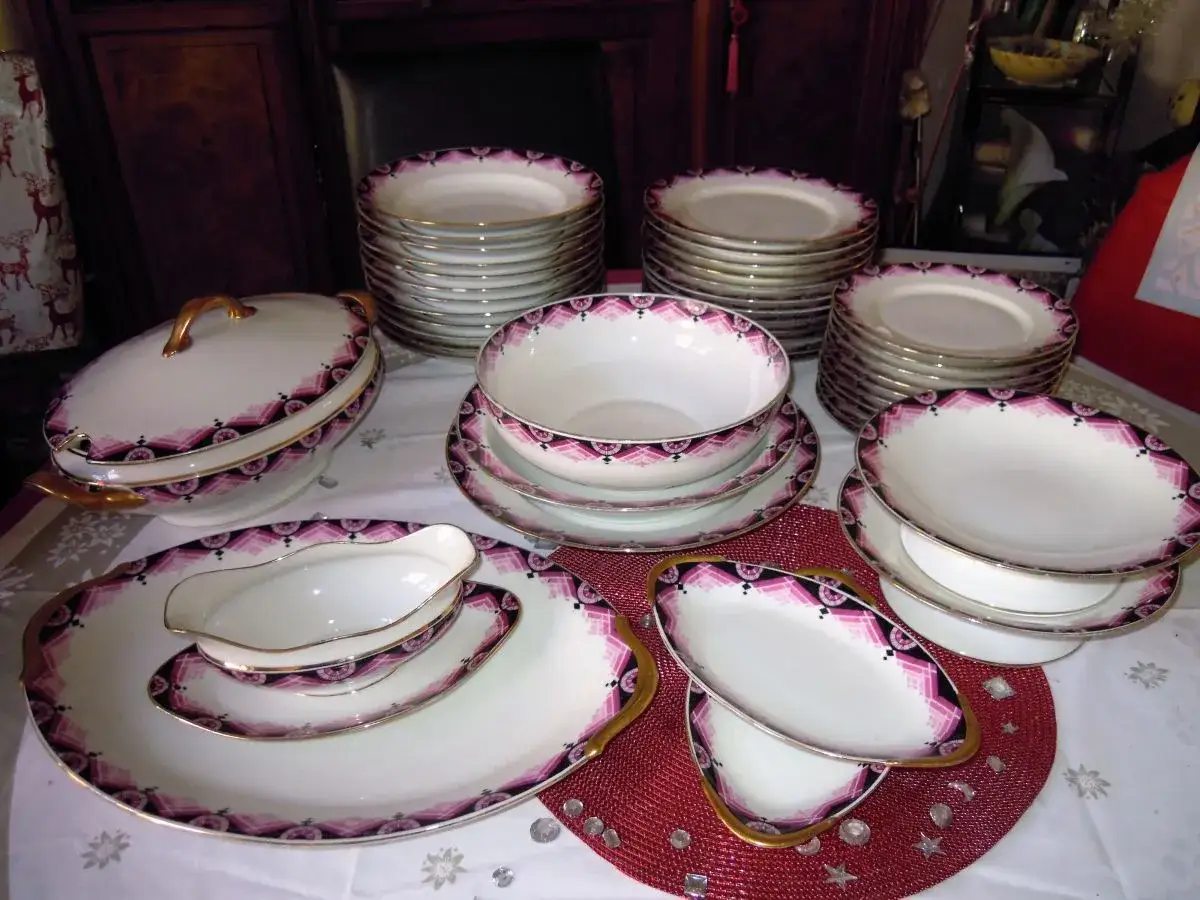 Service de vaisselle en porcelaine &agrave; la cendre d'os, orn&eacute; d'un motif g&eacute;om&eacute;trique violet et noir, avec des touches dor&eacute;es.